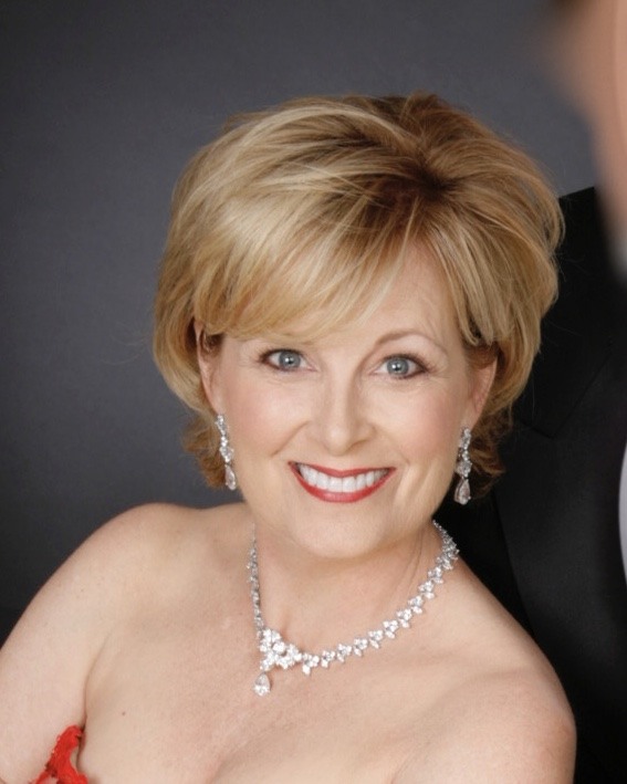 Laurie Gayle Stephenson smiling in an elegant concert portrait